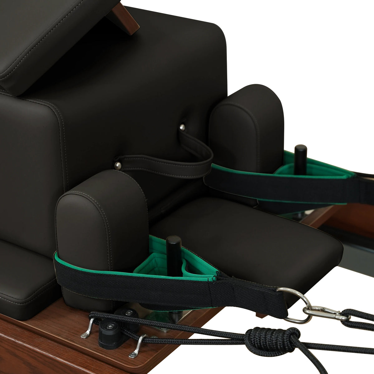 Black carriage headrest, shoulder rests and hand straps on a Gymfrog Cadillac Reformer Combo