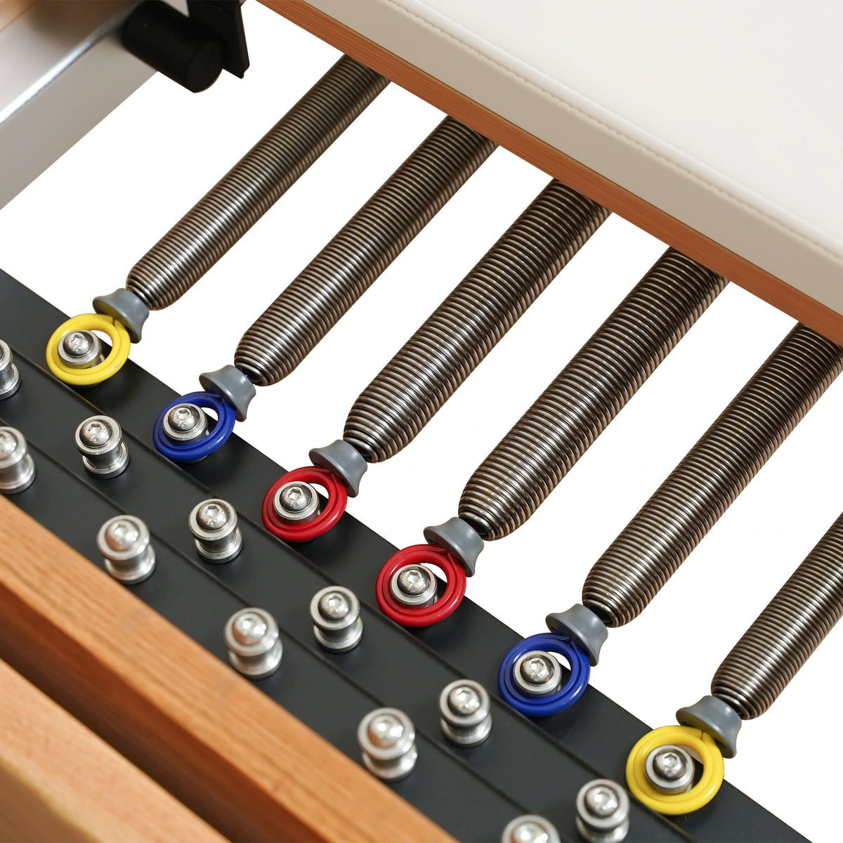 Color-coded Reformer springs and attachment points on a Gymfrog Cadillac Reformer Combo