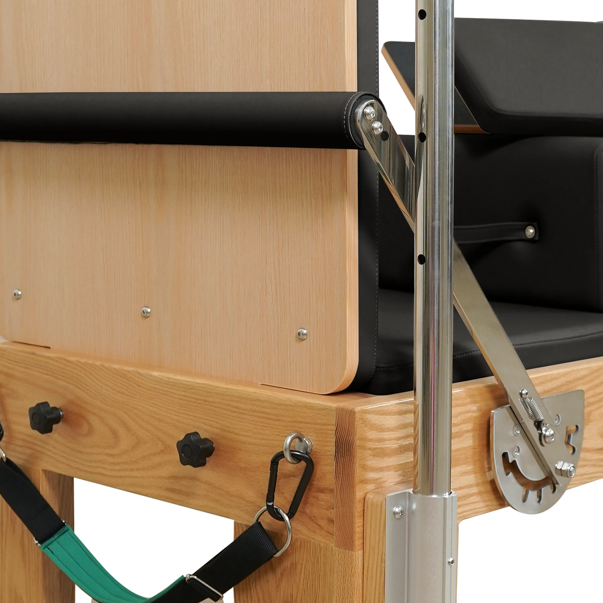 End panel, footbar adjustment bracket and attached strap on a Gymfrog Cadillac Reformer Combo