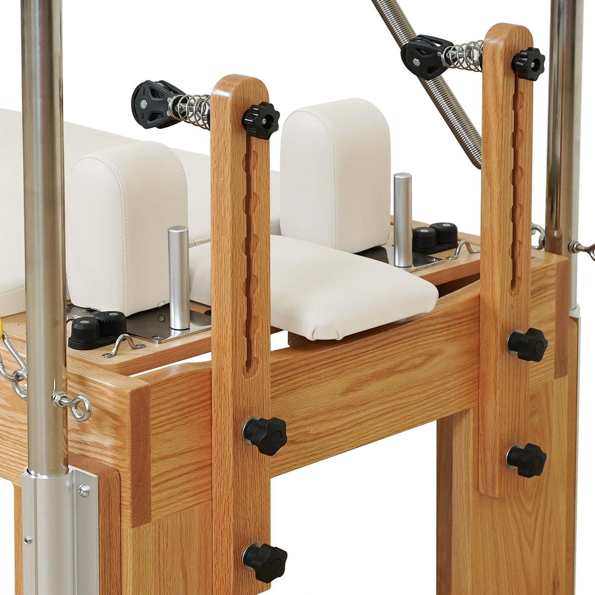 Adjustable wooden pulley risers and locking knobs on a Gymfrog Cadillac Reformer Combo