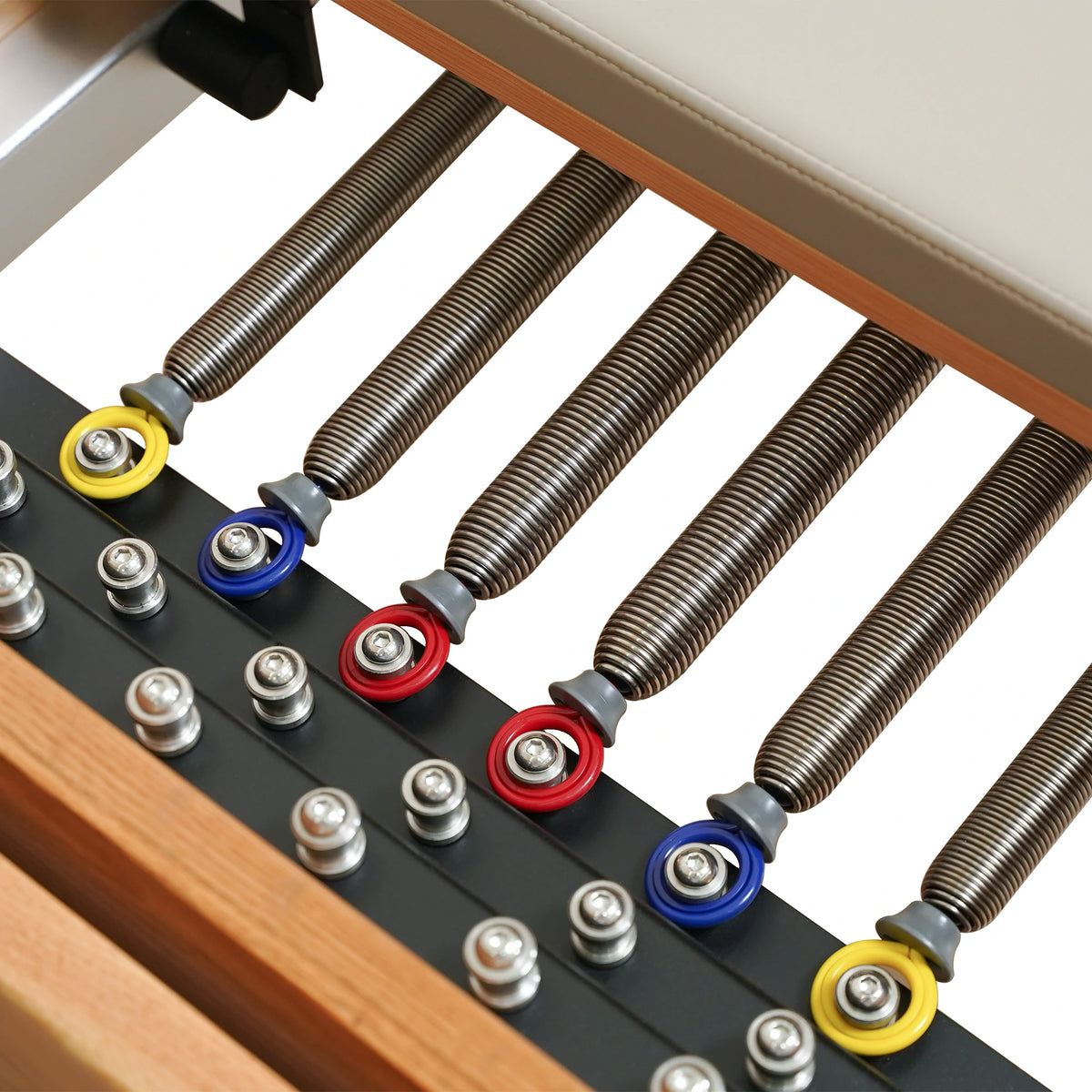 Color-coded Reformer springs and attachment points on a Gymfrog Cadillac Reformer Combo