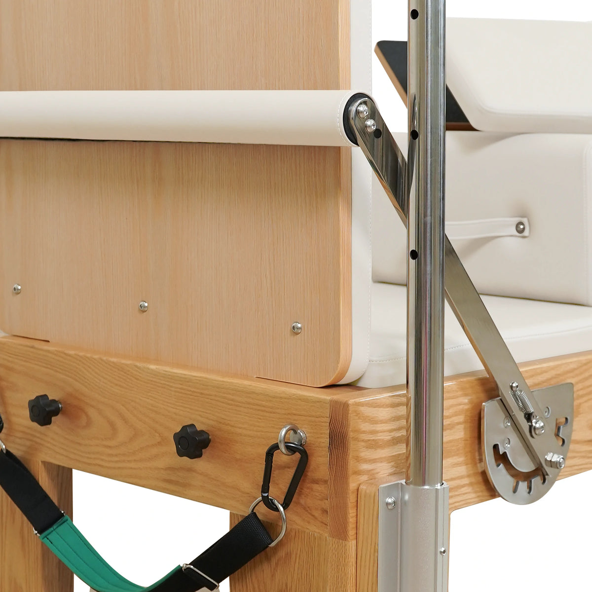 End panel, footbar adjustment bracket and attached strap on a Gymfrog Cadillac Reformer Combo