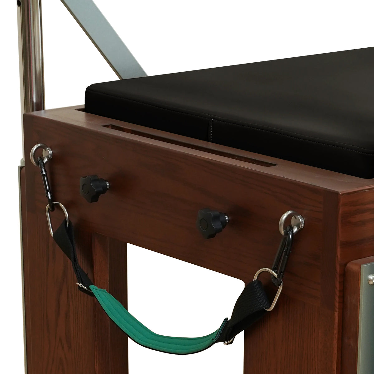 Walnut-finish end panel, attachment knobs and green strap on a Gymfrog Cadillac Reformer Combo