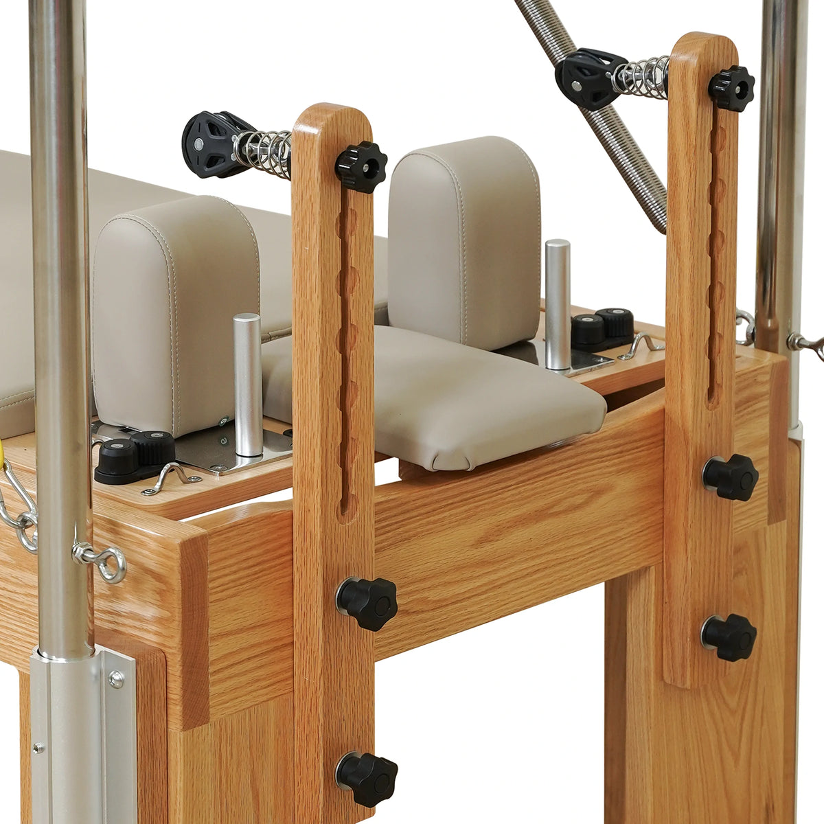 Adjustable wooden pulley risers and locking knobs on a Gymfrog Cadillac Reformer Combo