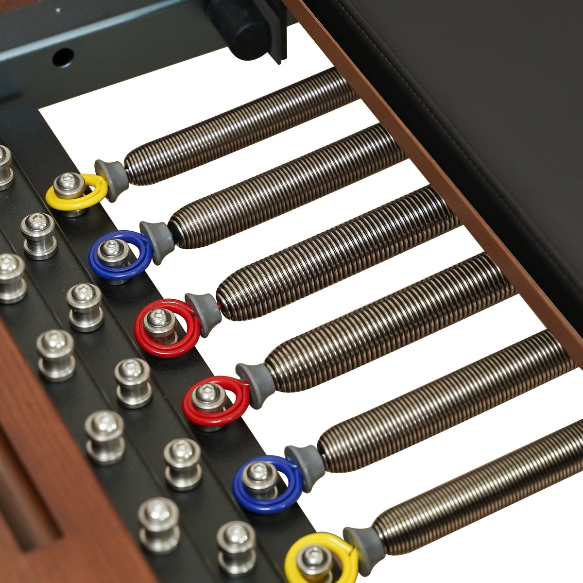 Color-coded Reformer springs and attachment points on a Gymfrog Cadillac Reformer Combo