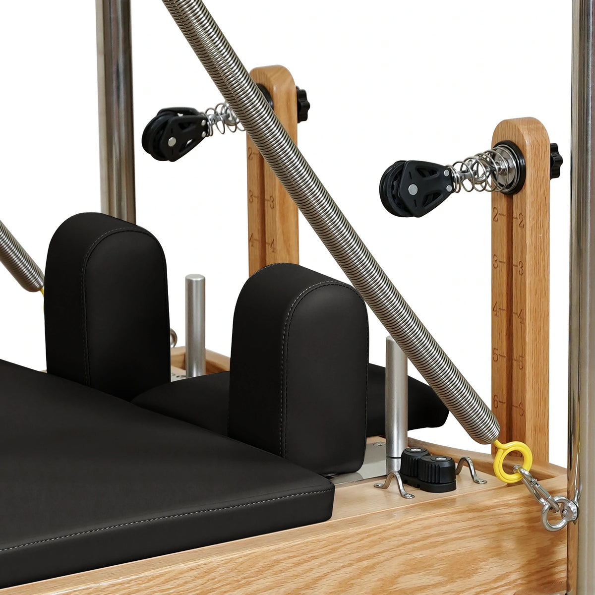 Black carriage headrest, shoulder rests and pulley detail on a Gymfrog Cadillac Reformer Combo