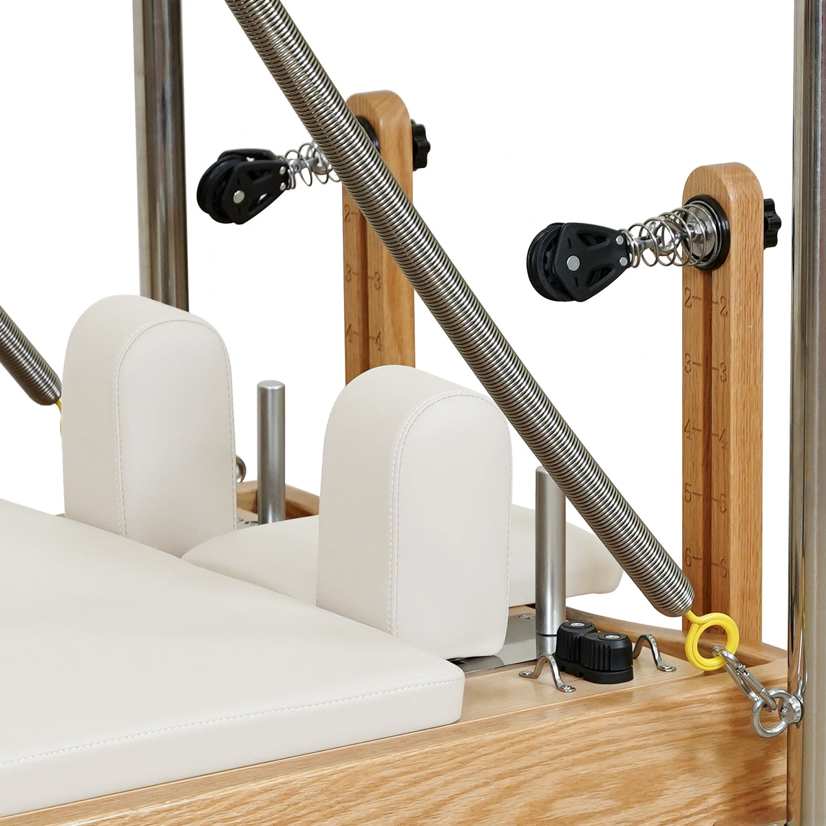Beige carriage headrest, shoulder rests and pulley detail on a Gymfrog Cadillac Reformer Combo